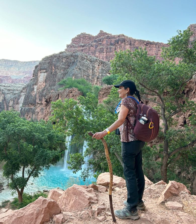 Deb overlooking the sparkling blue-green waterfalls stewarded by the Havasupai Tribe