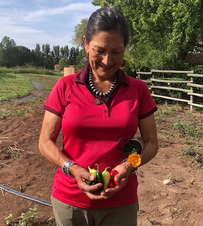 Deb holding freshly picked chile peppers